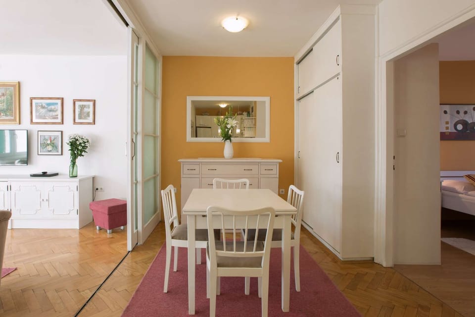 View from the kitchen to the dining area, living room on the left and bedroom on the right.