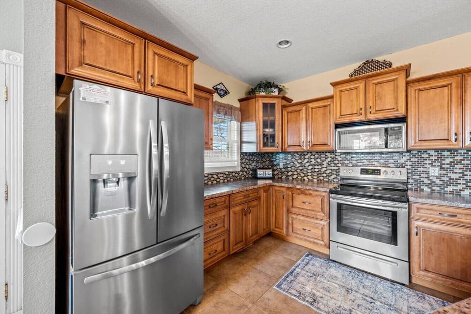 Kitchen is fully stocked with pots/pans, cookware, dishware, bakeware, utensils and appliances.