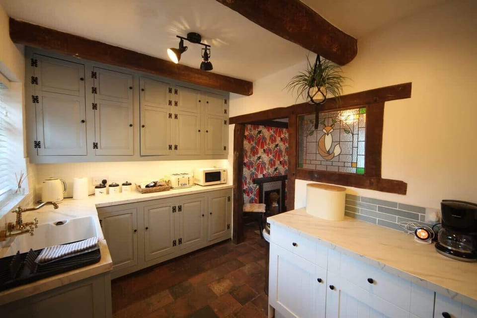 The Kitchen: adding to the charm of this property, the cottage's original bespoke kitchen units have been lovingly restored.
