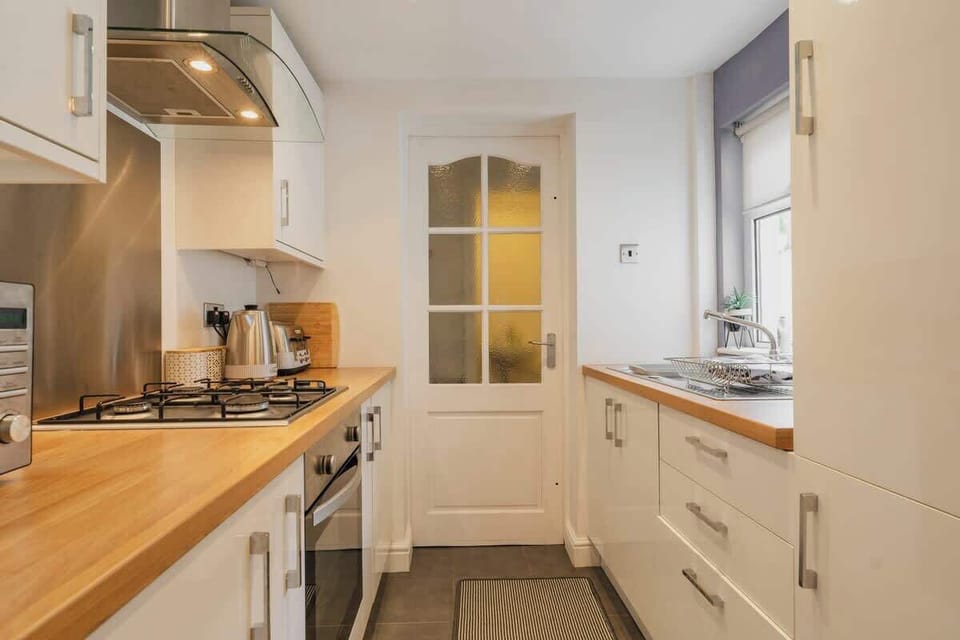 The Kitchen: The modern galley kitchen is a great space for self-catering during your stay. There is a  handy w/c at the rear.