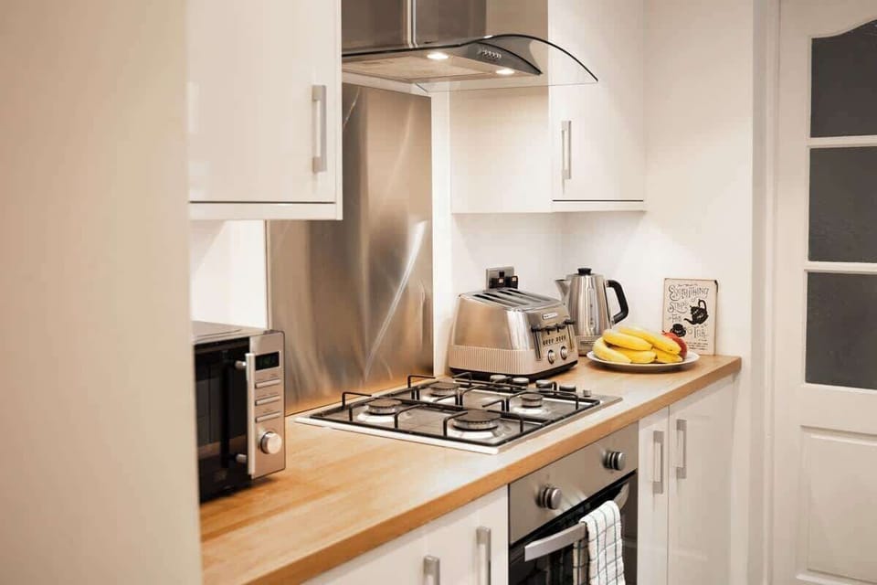 The Kitchen: the contemporary kitchen comes with all amenities needed for a comfortable stay.