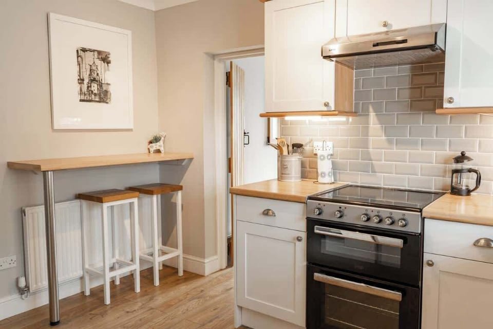 The Kitchen: the modern shaker style kitchen comes well equipped with everything you need to have a comfortable stay, it also has breakfast bar seats for you to sit and enjoy your morning drink or breakfast.