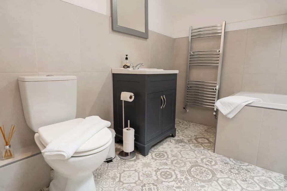 Home 1 - Bathroom 1: unwind and refresh in this stunning and modern bathroom.