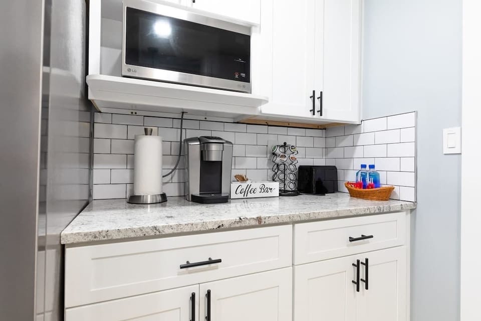 Keurig Coffee Maker & Carousel w/ variety of pods. Modern microwave & toaster. Additionally we have some treats for guests!