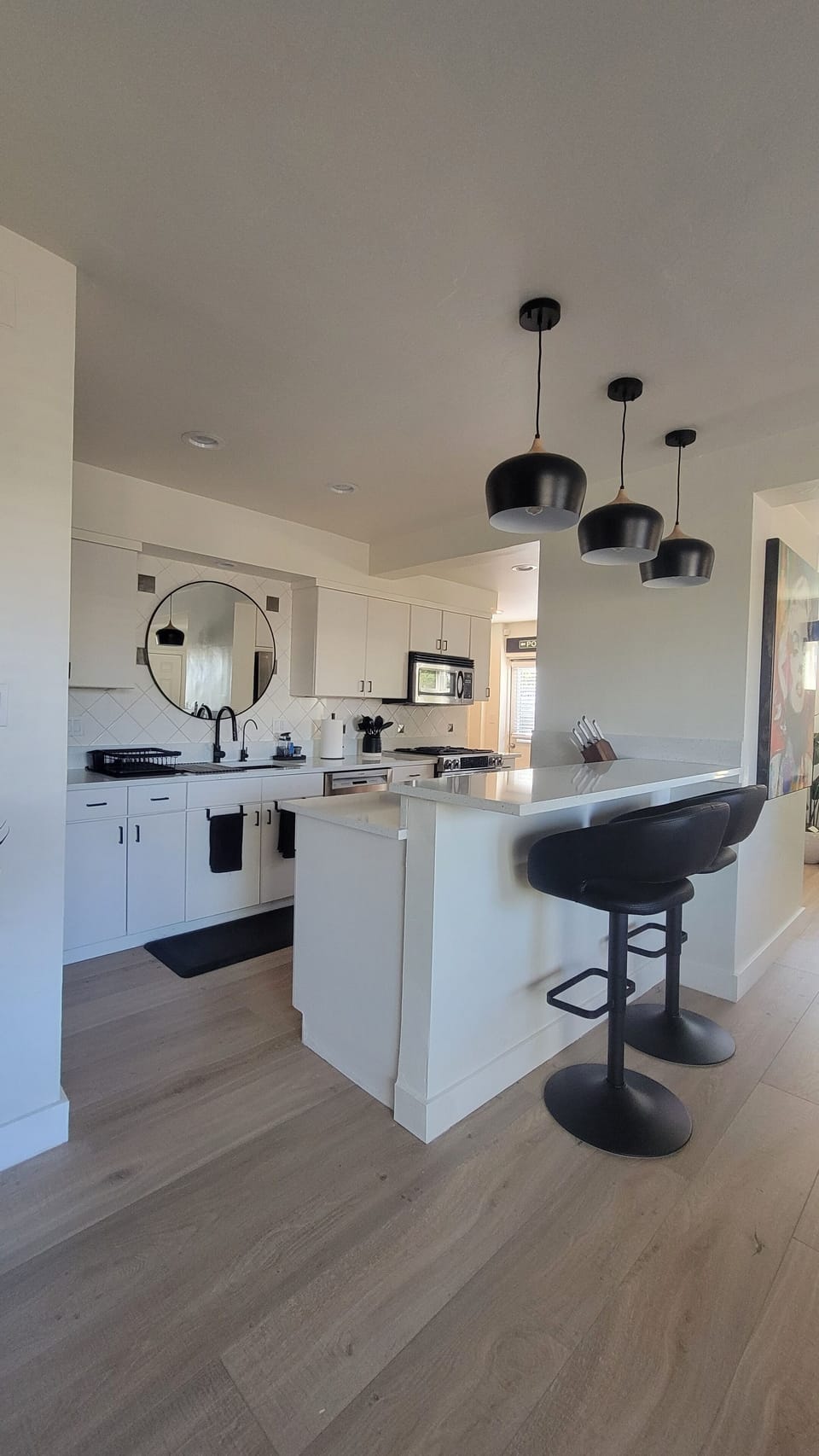 View from living room into fully stocked kitchen. Just bring food and drinks.