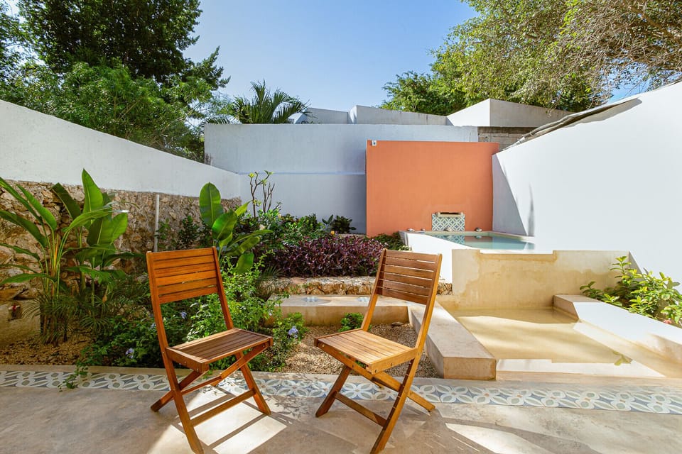Large backyard with garden, pool, dining area, and outdoor furniture.