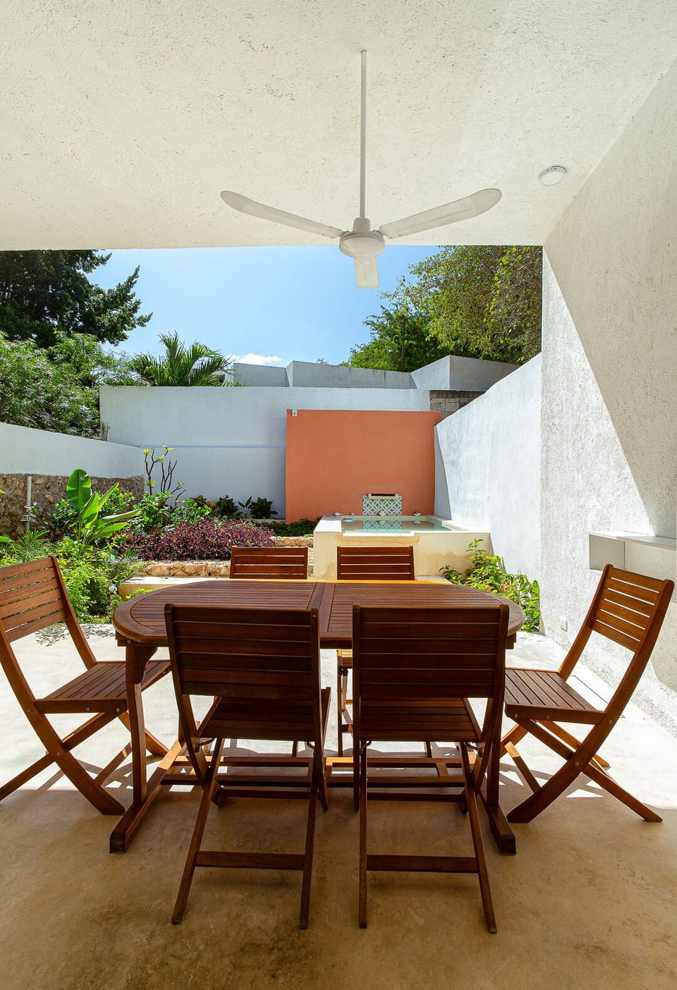 Large backyard with garden, pool, dining area, and outdoor furniture.