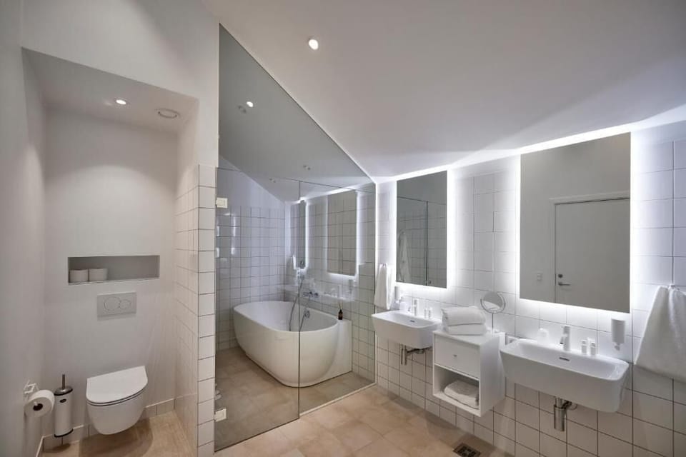 Deluxe Suite, Ocean View | Bathroom | Separate tub and shower, hair dryer, towels, soap