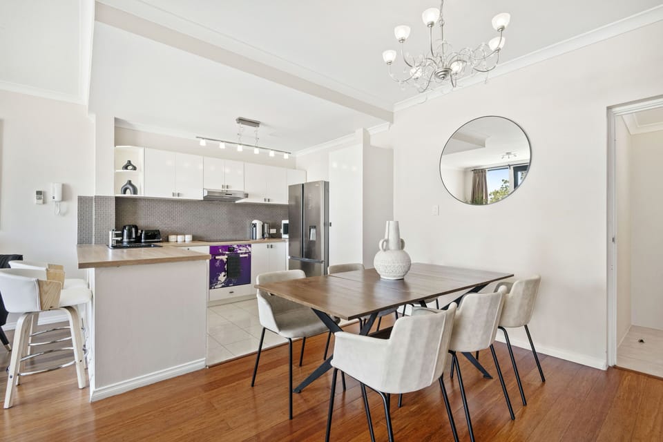Discover a sophisticated and elegant living space, featuring a formal dining area, a well-appointed kitchen, and a touch of elegant charm.