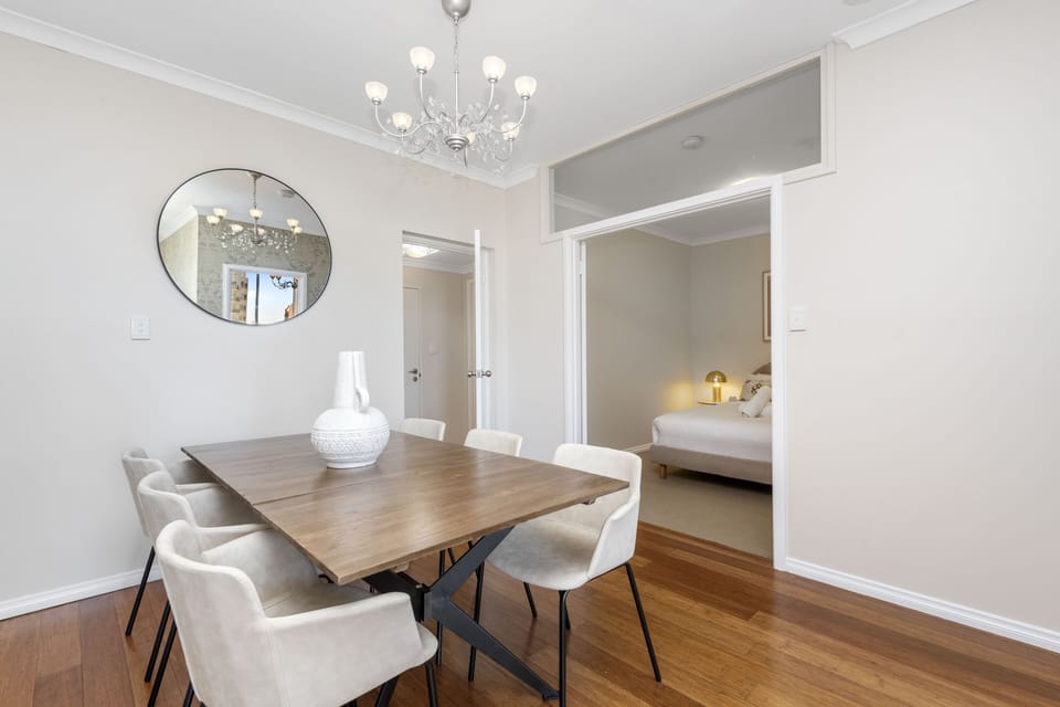 Gather around the elegant dining table, perfect for entertaining guests or enjoying family meals in this bright and airy space.