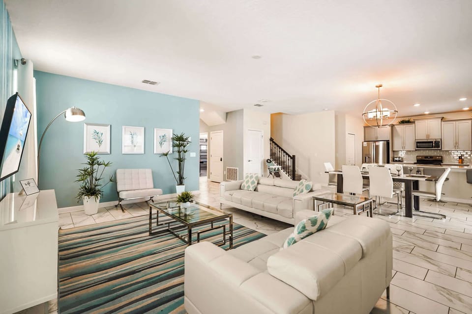 Experience luxury in this modern open-plan living area with stylish decor and ample seating, perfect for family gatherings.
