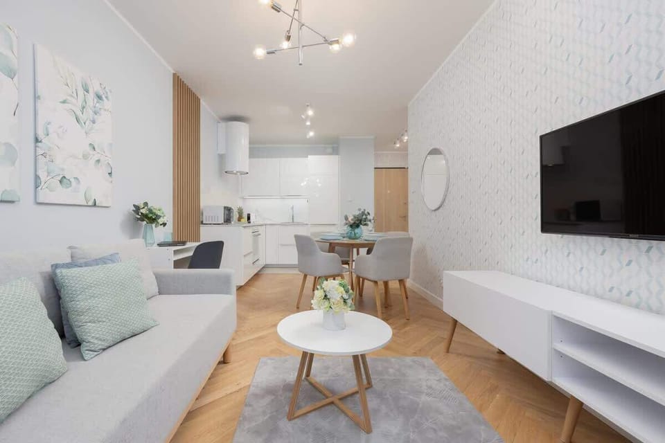Living room with a double sofa bed, TV and fully equipped kitchenette and dining area