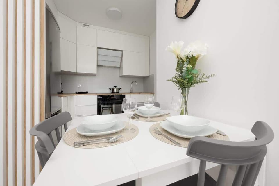 A stylish kitchen with white cabinetry, a built-in oven, and a compact but functional design for everyday convenience.

