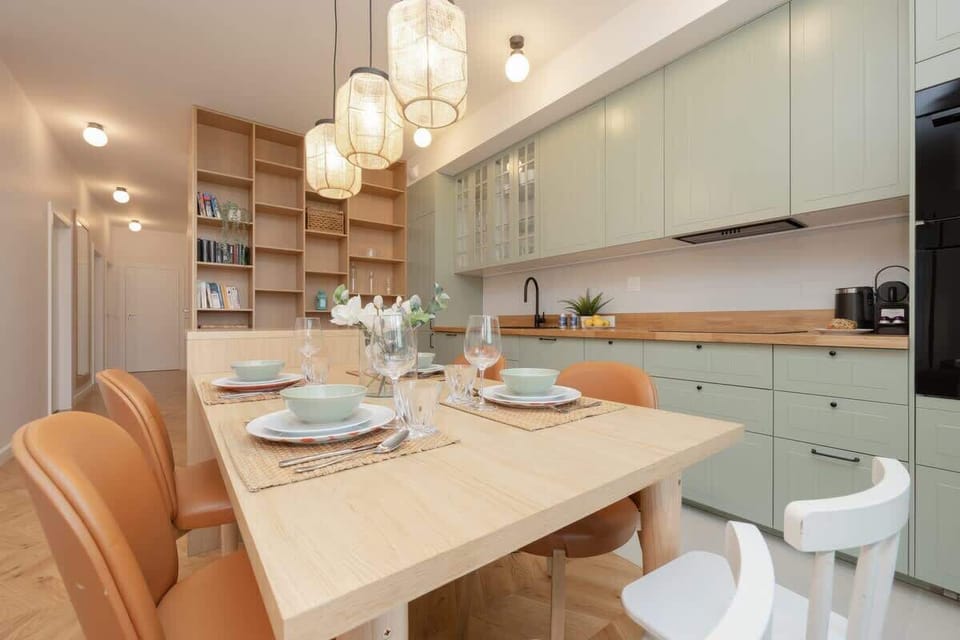 A beautifully set dining table with warm lighting, stylish chairs, and an elegant, inviting ambiance for family meals.

