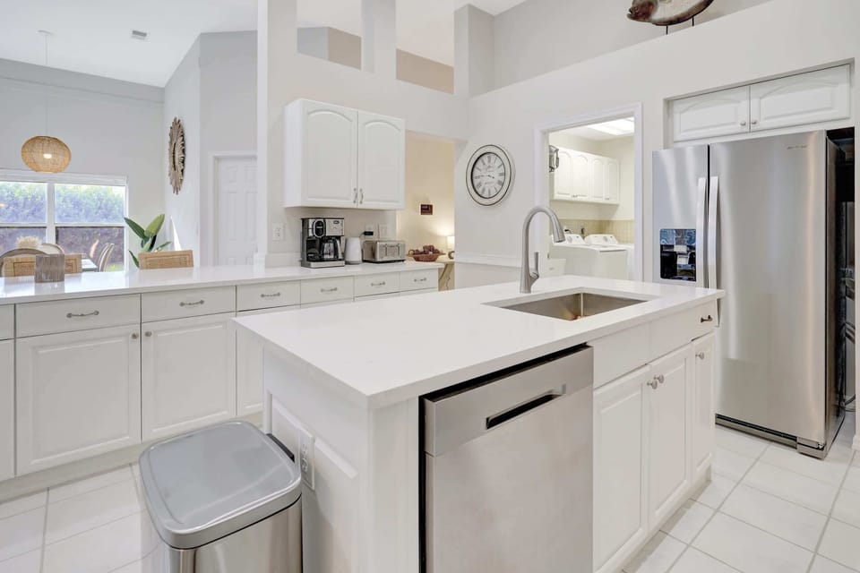 A center island in the kitchen contains the dishwasher and sink