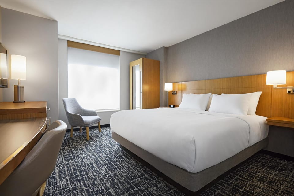 Premium bedding, down comforters, Tempur-Pedic beds, desk