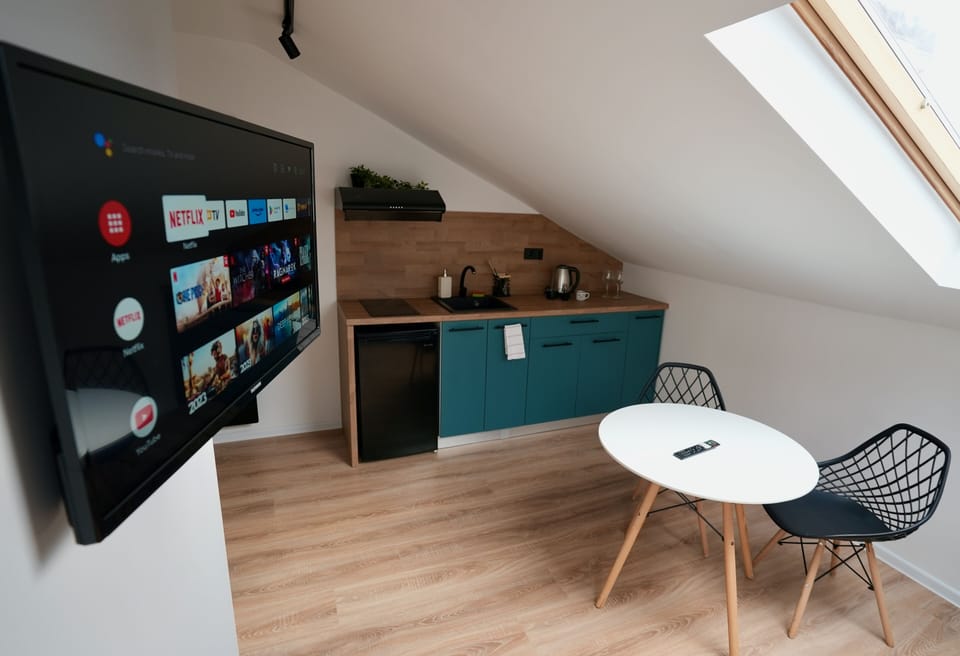 Sofa, smart Tv and kitchenette fully equipped. (2)