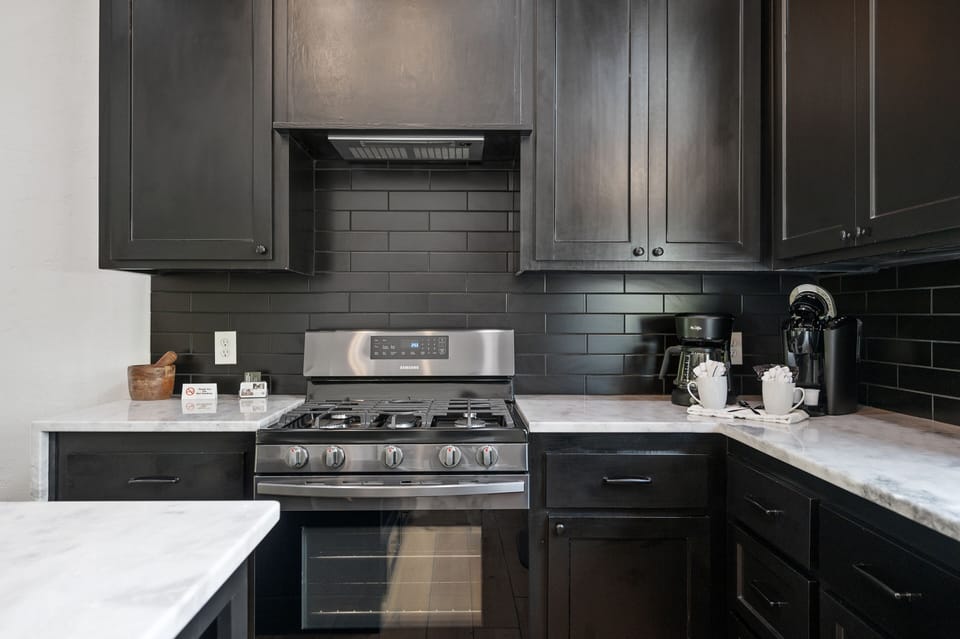 Black on black on black! This clean modern kitchen will have you thinking remodel when you get home...