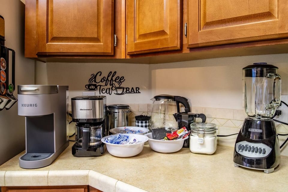 Caffee and Tea Station equipped with a Keurig appliance, drip coffee maker, and French press coffee maker.