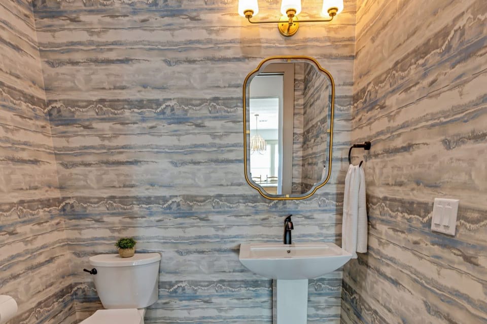 Convenience meets coastal charm in our half bathroom off the kitchen