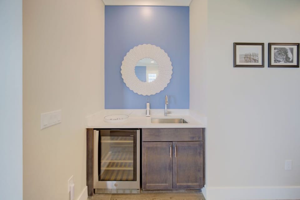 A well-appointed bathroom featuring dark cabinetry and a walk-in shower.