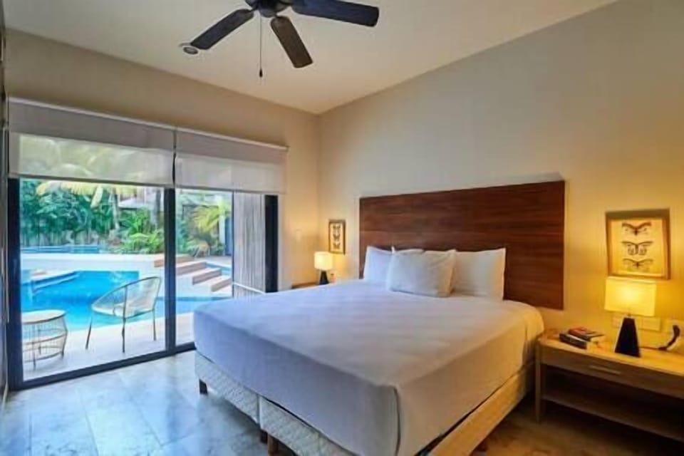 Luxury master suite: King bed, wall closet, pool access.