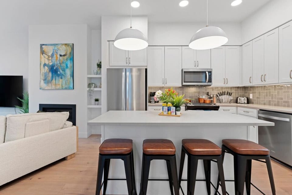 Open plan kitchen, living room and walk out patio are located on the main floor with a half bath and dedicated office space.