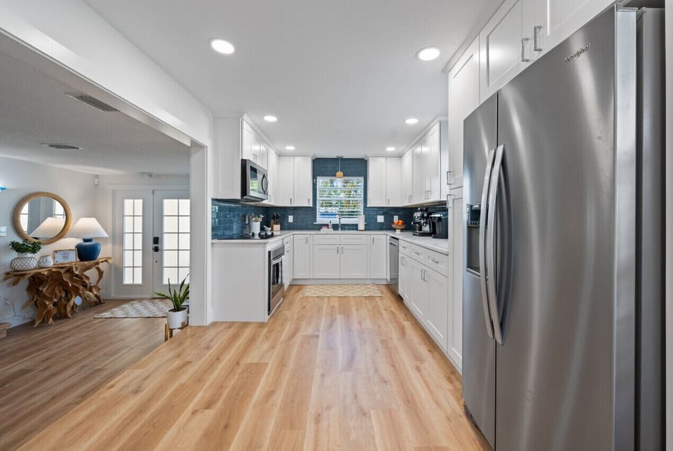 Open kitchen with chef cookware and new appliances