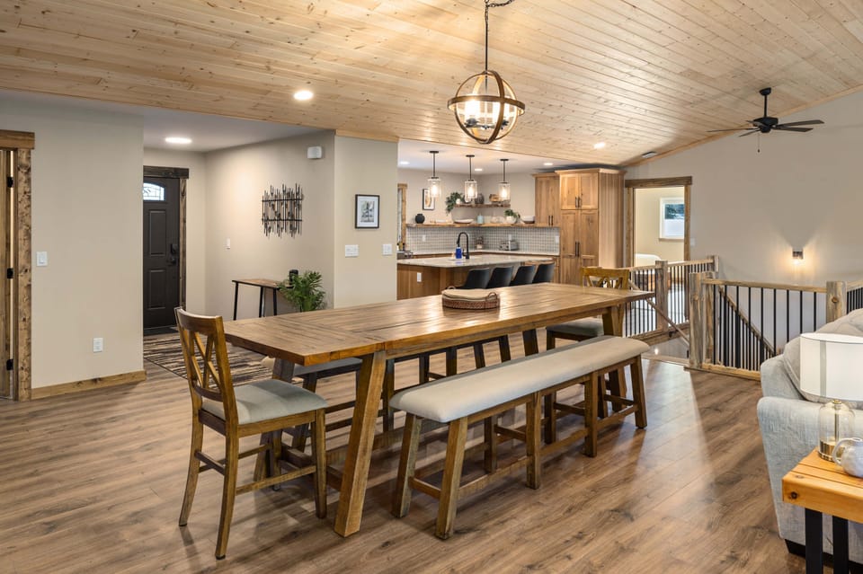Large dining room table that seats 12 to 14 with seating for another 4 at the bar.