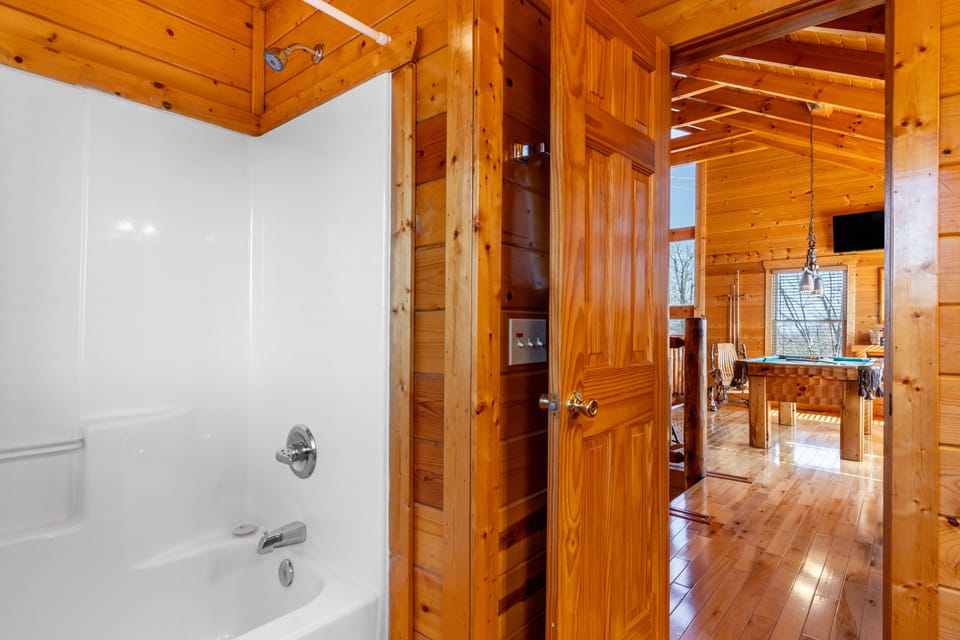 Bathroom 2 is near the pool table area and features a shower/tub combo.