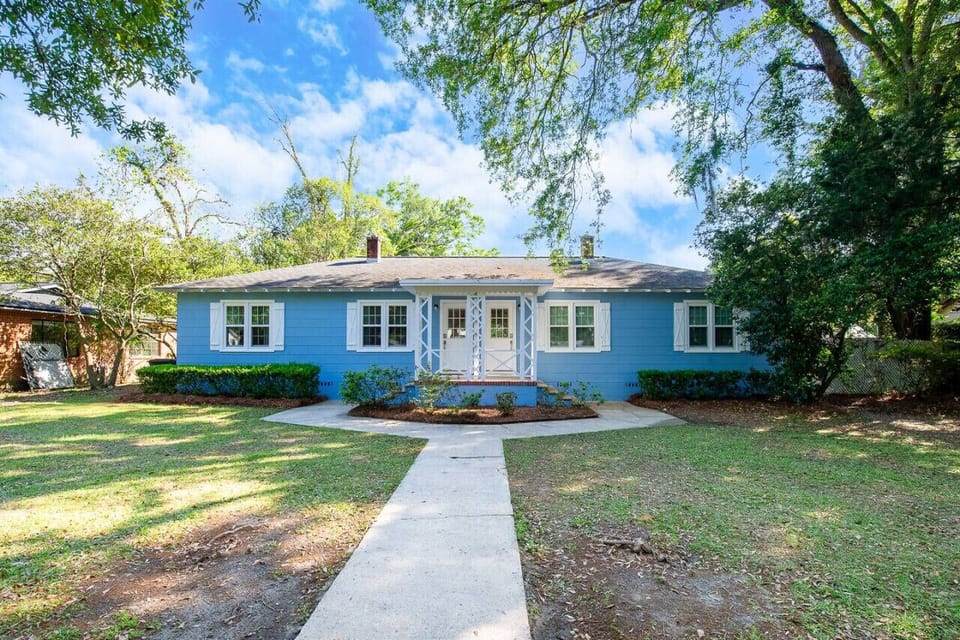 Cottage shaded by mature trees