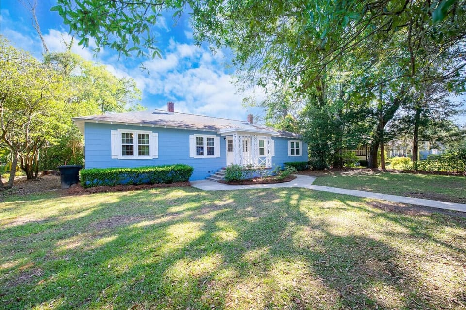 Cottage shaded by mature trees