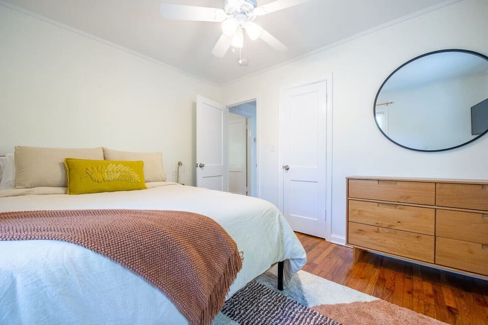 Comfy queen sized bed adorned with super soft sheets and 6 plush pillows! Bedside lights with USB ports. Smart TV.
