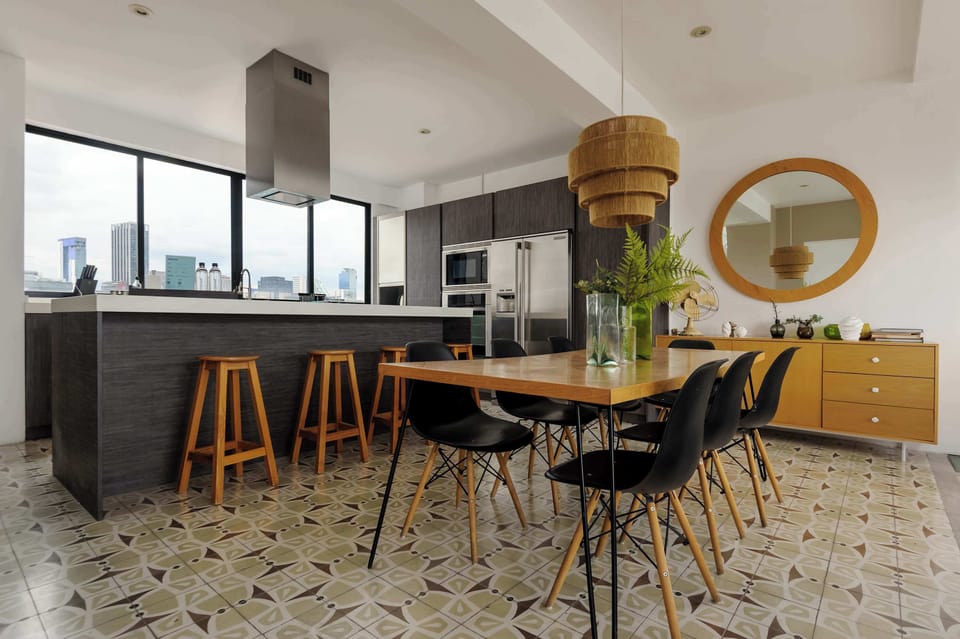 Modern dining table near large windows.