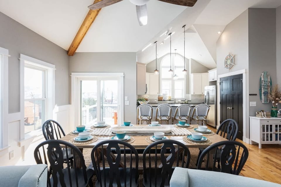 Bright Dining Area w/ Large Table and Bench, Vaulted Ceilings, and Open Kitchen Access 