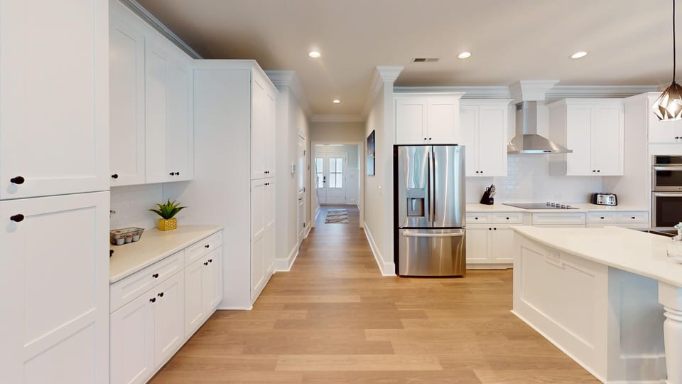 High-end appliances, sleek countertops, and ample cabinetry make this kitchen perfect for family meals and entertaining.