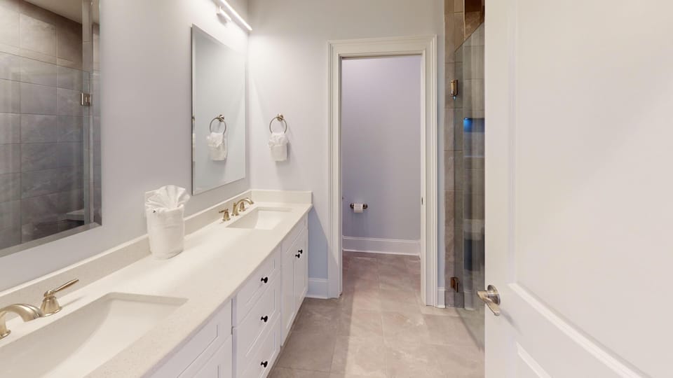 Spacious bathroom featuring modern fixtures, a walk-in shower, and high-quality finishes.