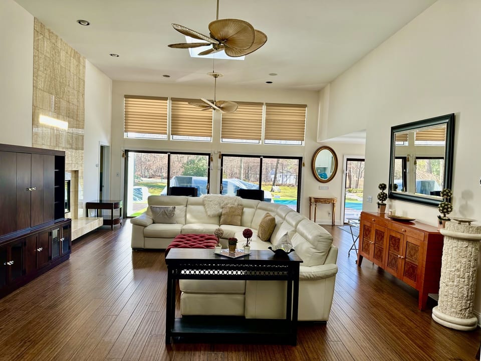 Large high ceiling living room with lots of light and easy access to the pool