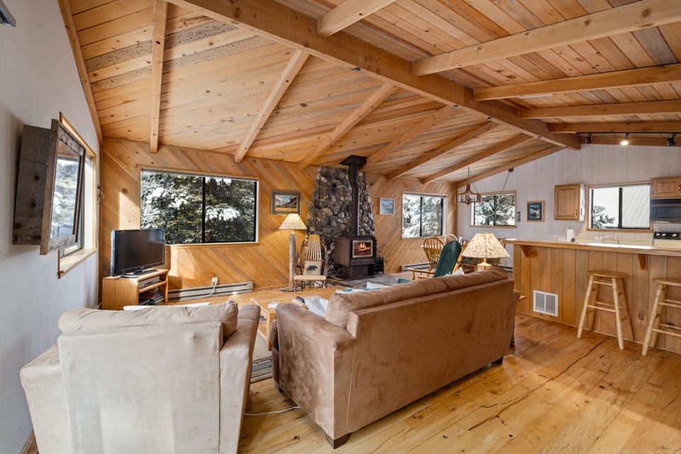 Distressed hard wood floors and exposed beams give a rustic cabin vibe