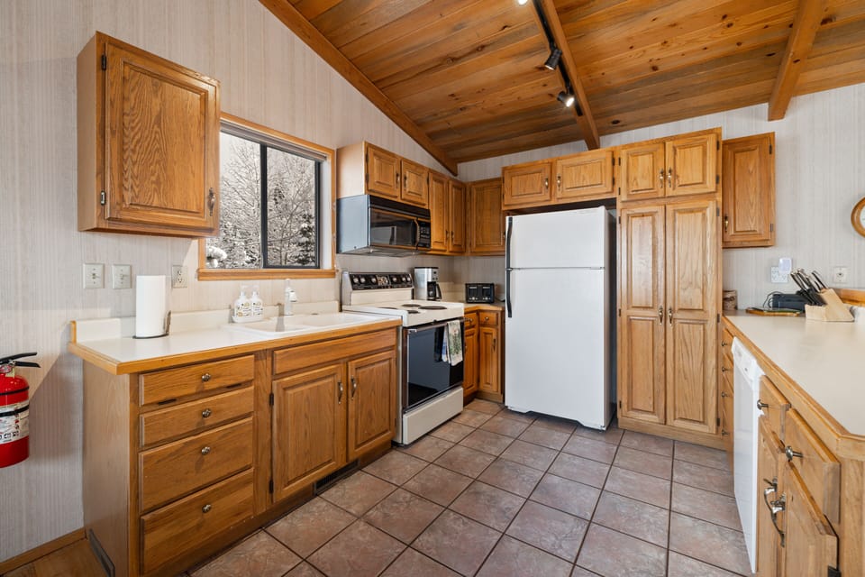 Kitchen is equipped with a generous pantry for food storage