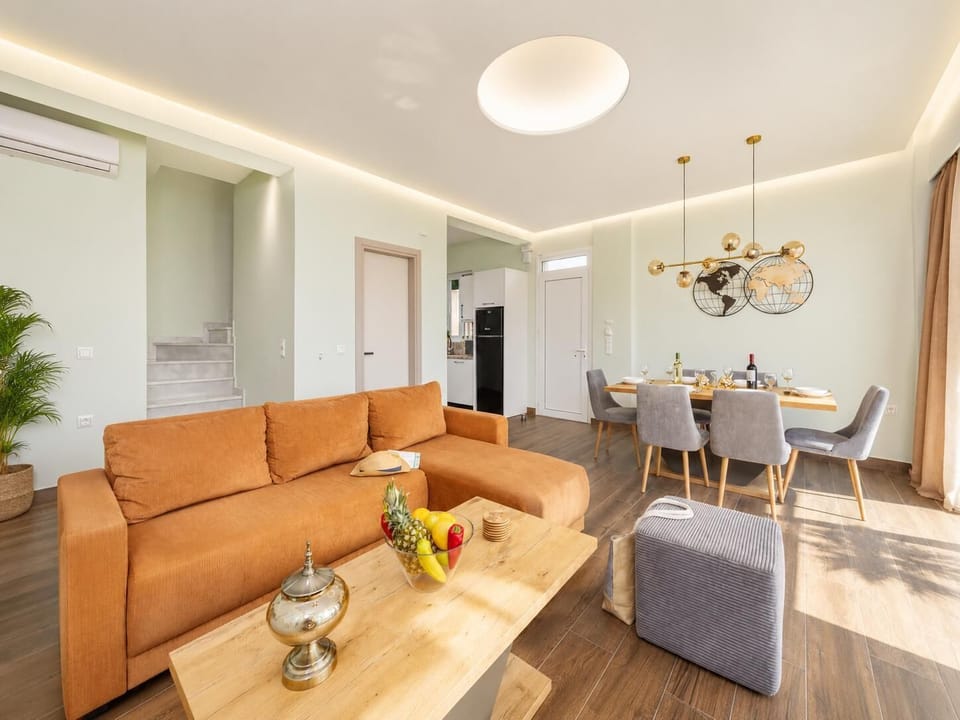 Open-plan living room with sofa, dining area, kitchen, A/C, WiFi internet, satellite TV, and sea views