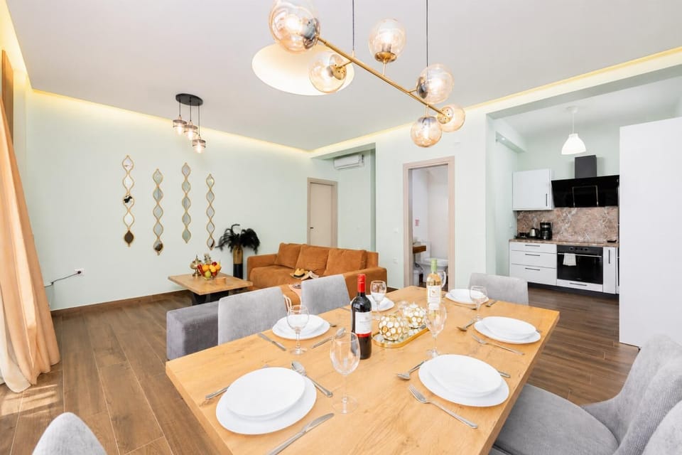Open-plan living room with sofa, dining area, kitchen, A/C, WiFi internet, satellite TV, and sea views