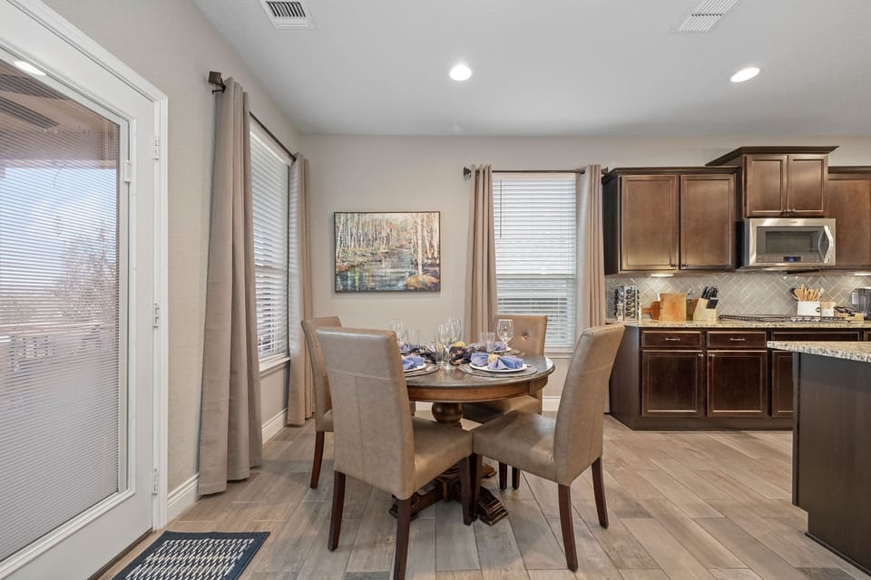 Kitchen table with adjacent bar seating - glasses, dishes, & silverware provided