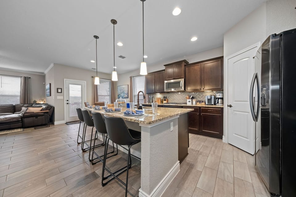 Kitchen has seating for 8, with 4 at the table and 4 at the bar.