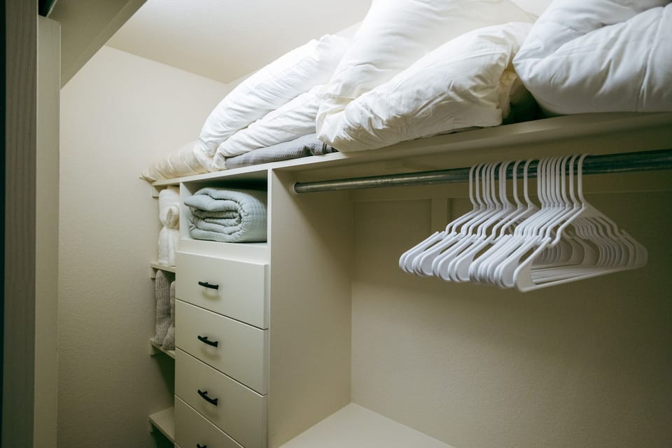 Main closet, Lots of blankets and linens as well as luggage racks and vacuum.