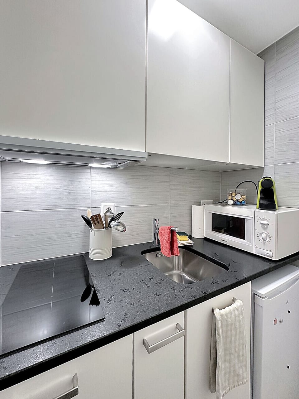 Pleasant dining area with functional kitchen.
