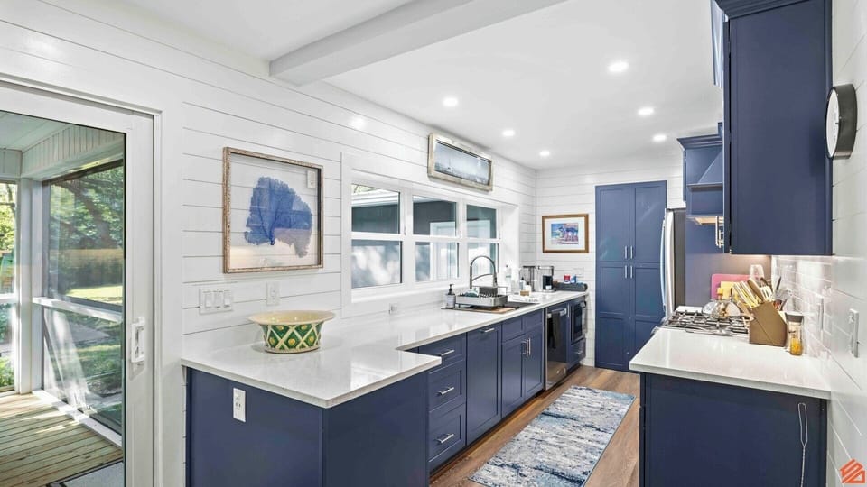 A stylish and functional kitchen featuring sleek countertops, high-end appliances, and abundant natural light, ideal for both cooking gourmet meals and socializing with friends and family.