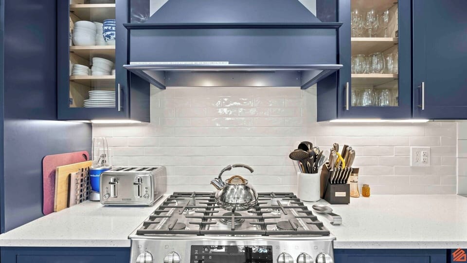 A modern and spacious kitchen equipped with state-of-the-art appliances and ample counter space, creating an inviting and efficient culinary environment for preparing meals and entertaining guests.