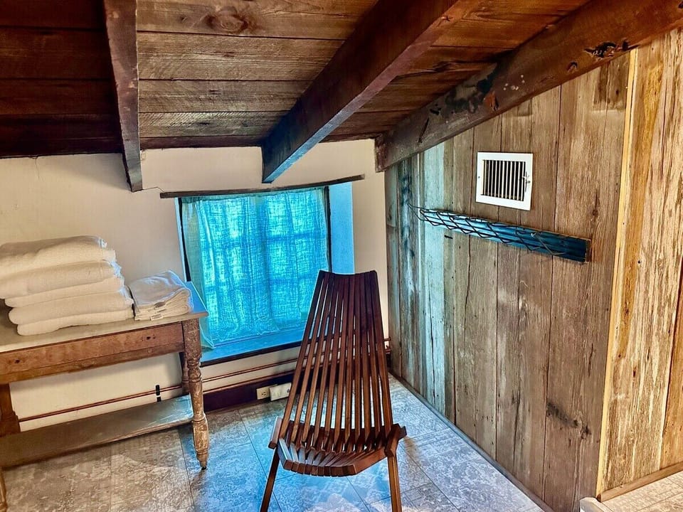 Nestled in a quiet corner, this cozy chair beckons with promises of warmth and relaxation