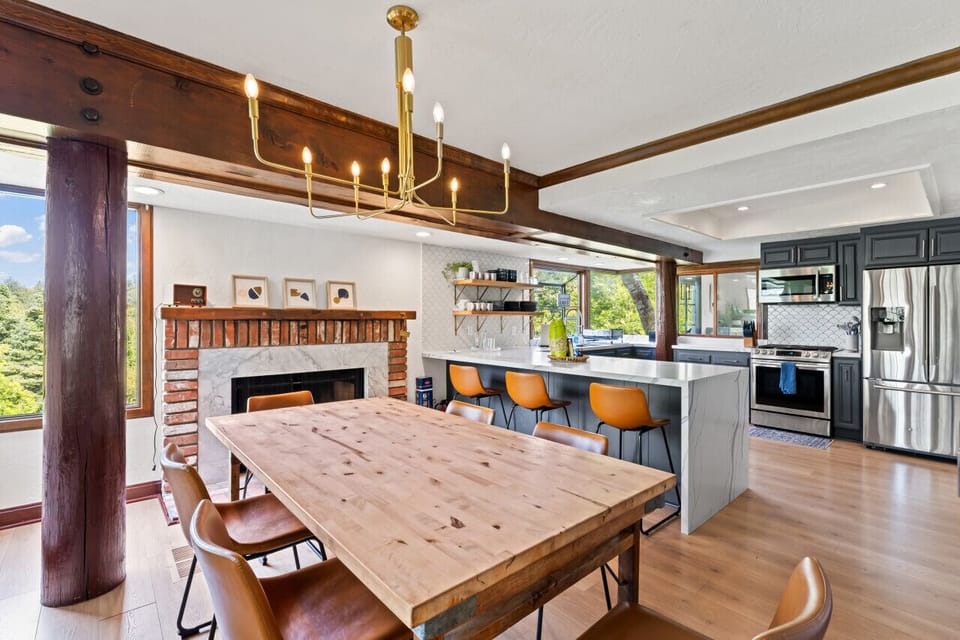Gather around the large dining table beside a kitchen island w/ bar seating for easy entertaining.